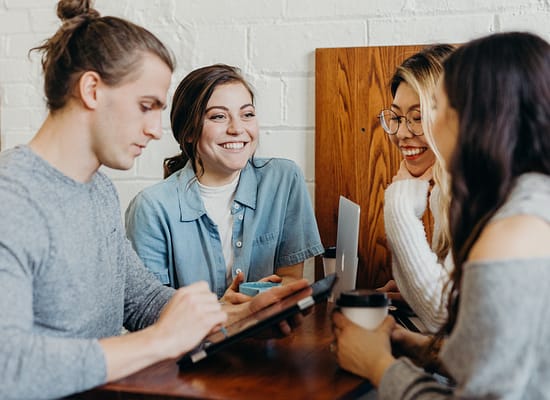 Group of coworking bonding over a common topic.